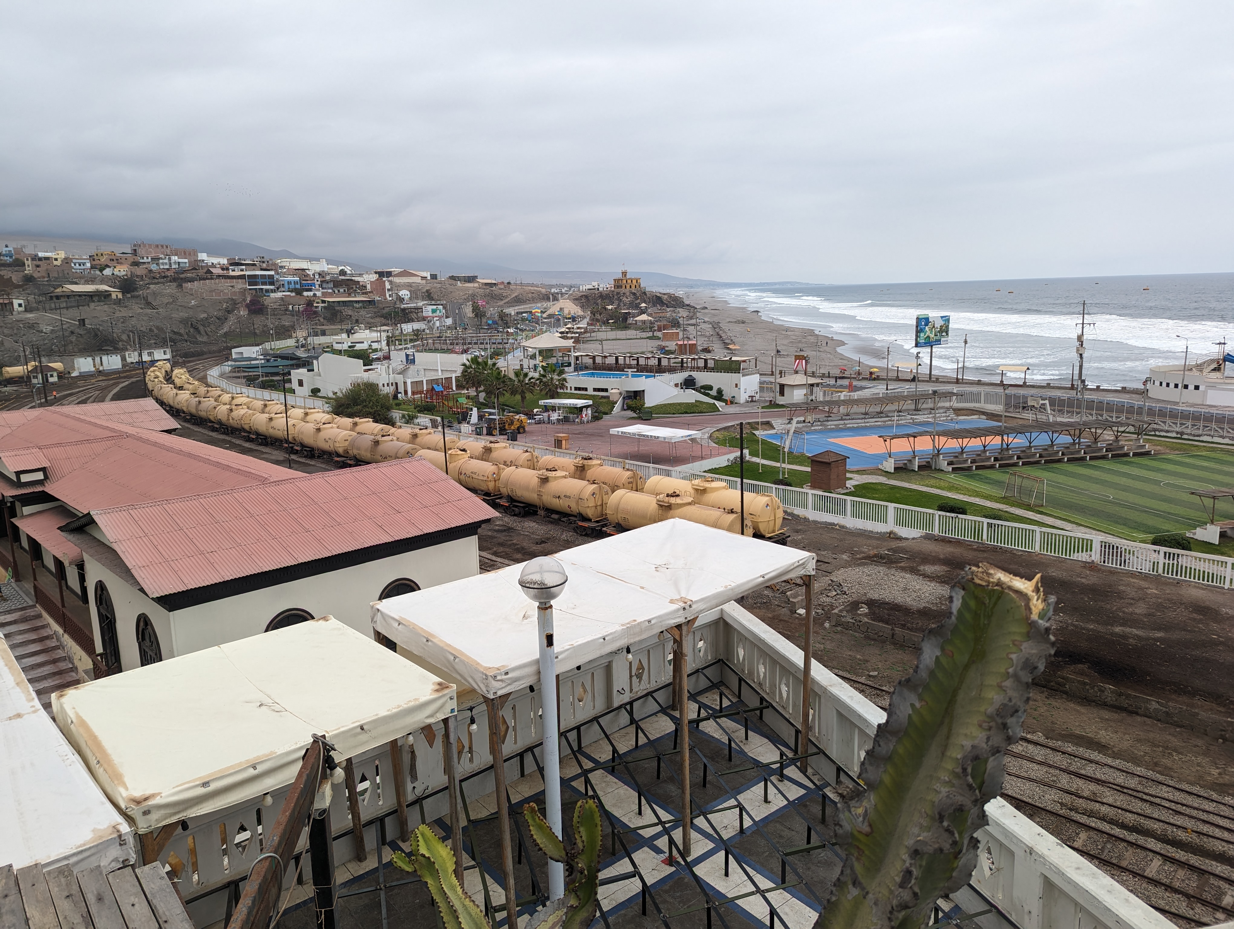 A view of the station, the deadend track, a sport facility, and the ocean.