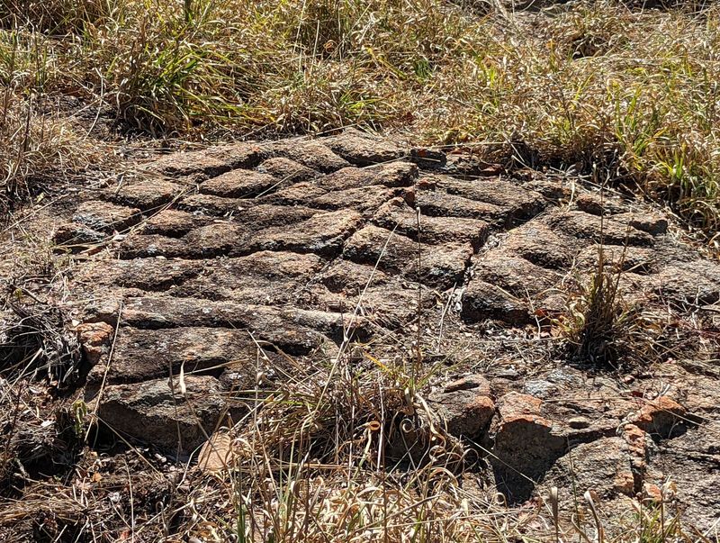 Outside the wall, there's a bit of bedrock sliced like this. Ideas?