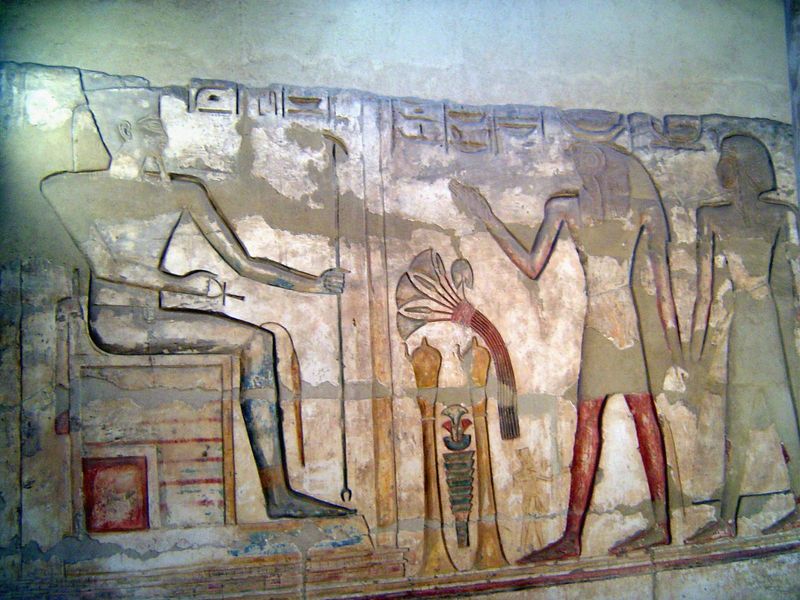In a room to the side, the king receives an offering from Thoth and a priest.
