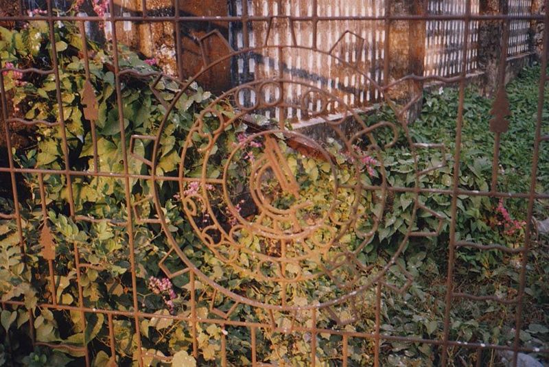 A side gate to the same school: the microscope in wrought-iron is a fine symbol of the missionaries' hopes of introducing science to Burma.