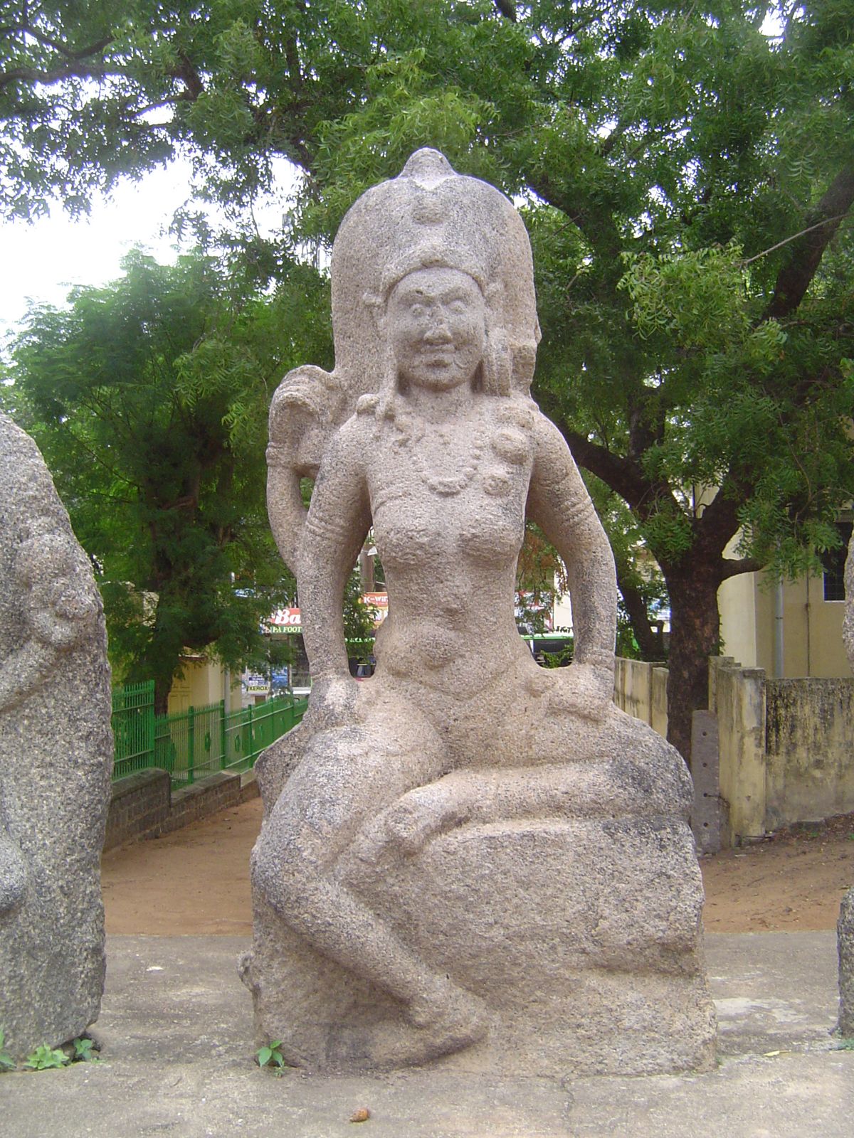 The largest, and the central figure, is Chamunda, who represents what time does to us all. Her earring ornament is a corpse; her necklace is
