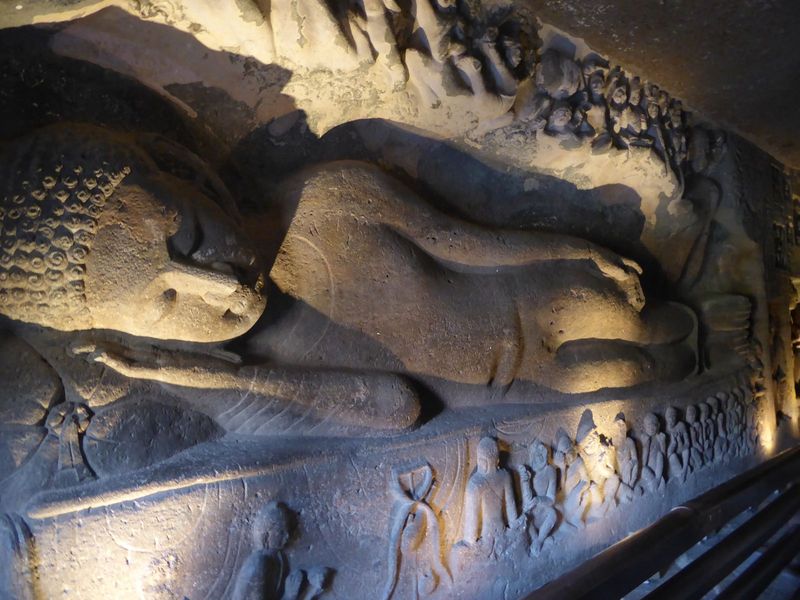 Here's something unusual for Ajanta. On the wall of the left aisle in Cave 26, there's this figure of the Buddha in Mahaparinirvana. The fig
