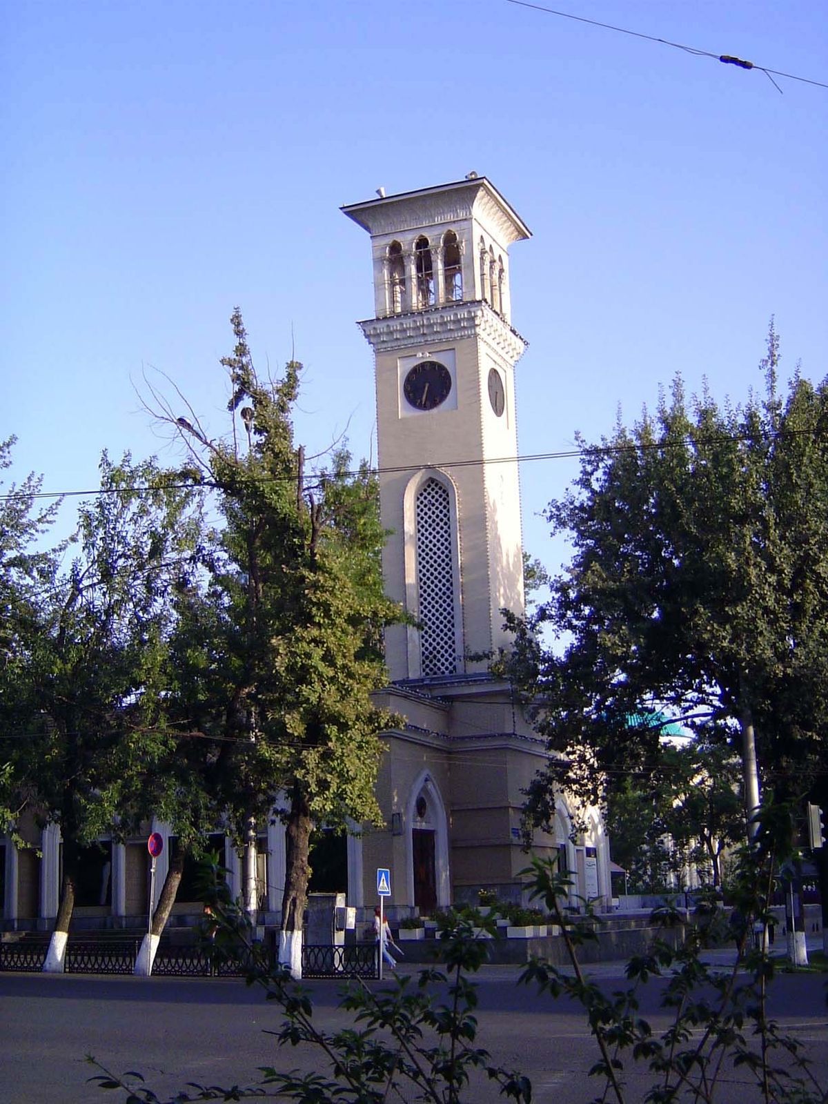 At the park's edge: a clocktower, the arch-symbol of progress.