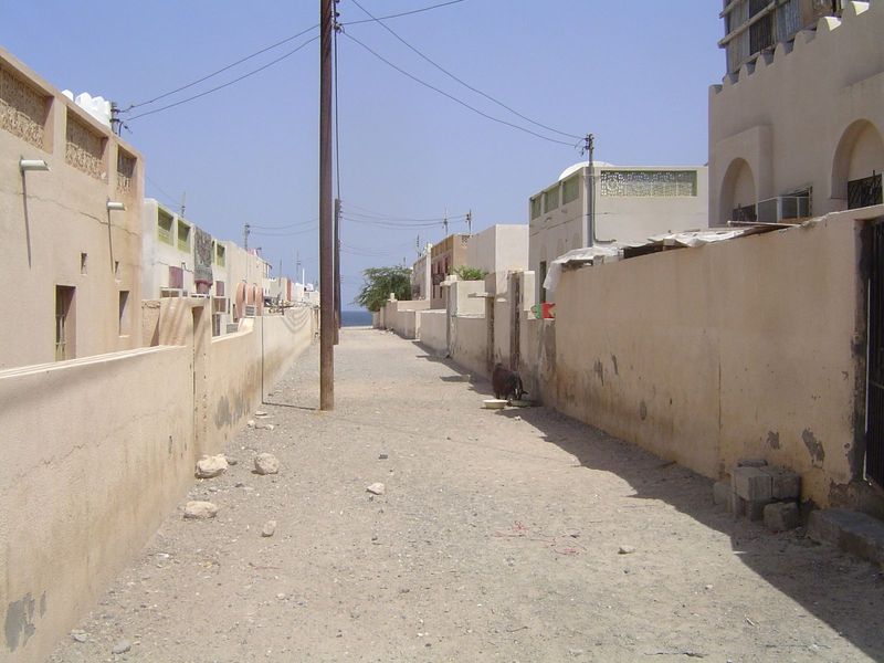 A lane without a speck of litter. Note the air conditioners and/or swamp coolers.