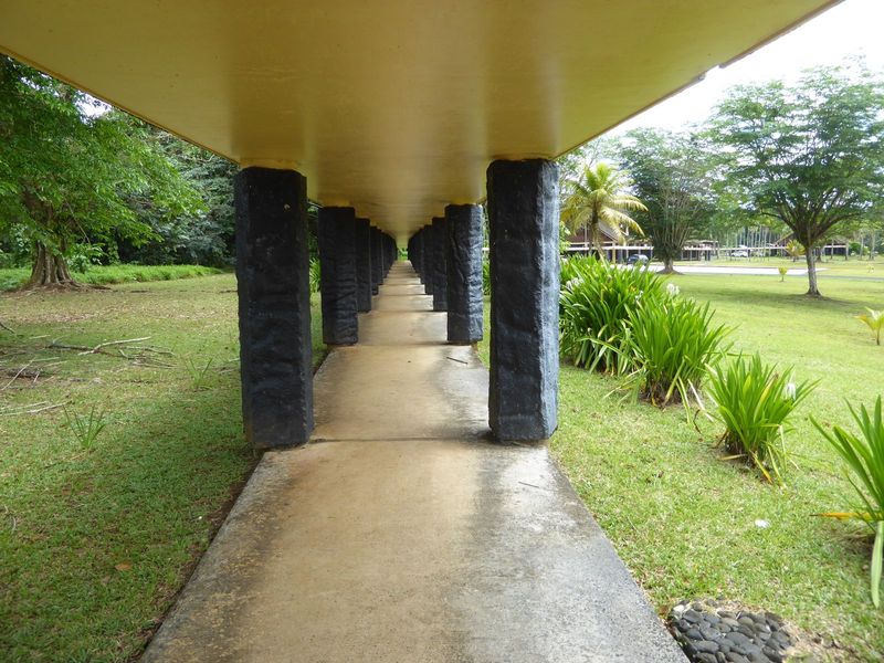 A corridor linking two buildings is lined with fake-basalt columns supposedly evoking the grandeur of the past. Who was the architect? I wis