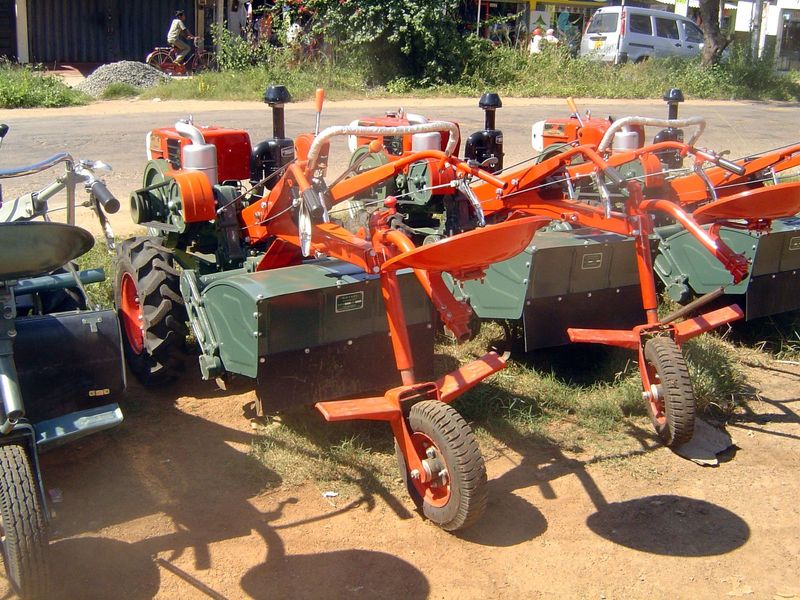 The tractors are equipped with cultivators.
