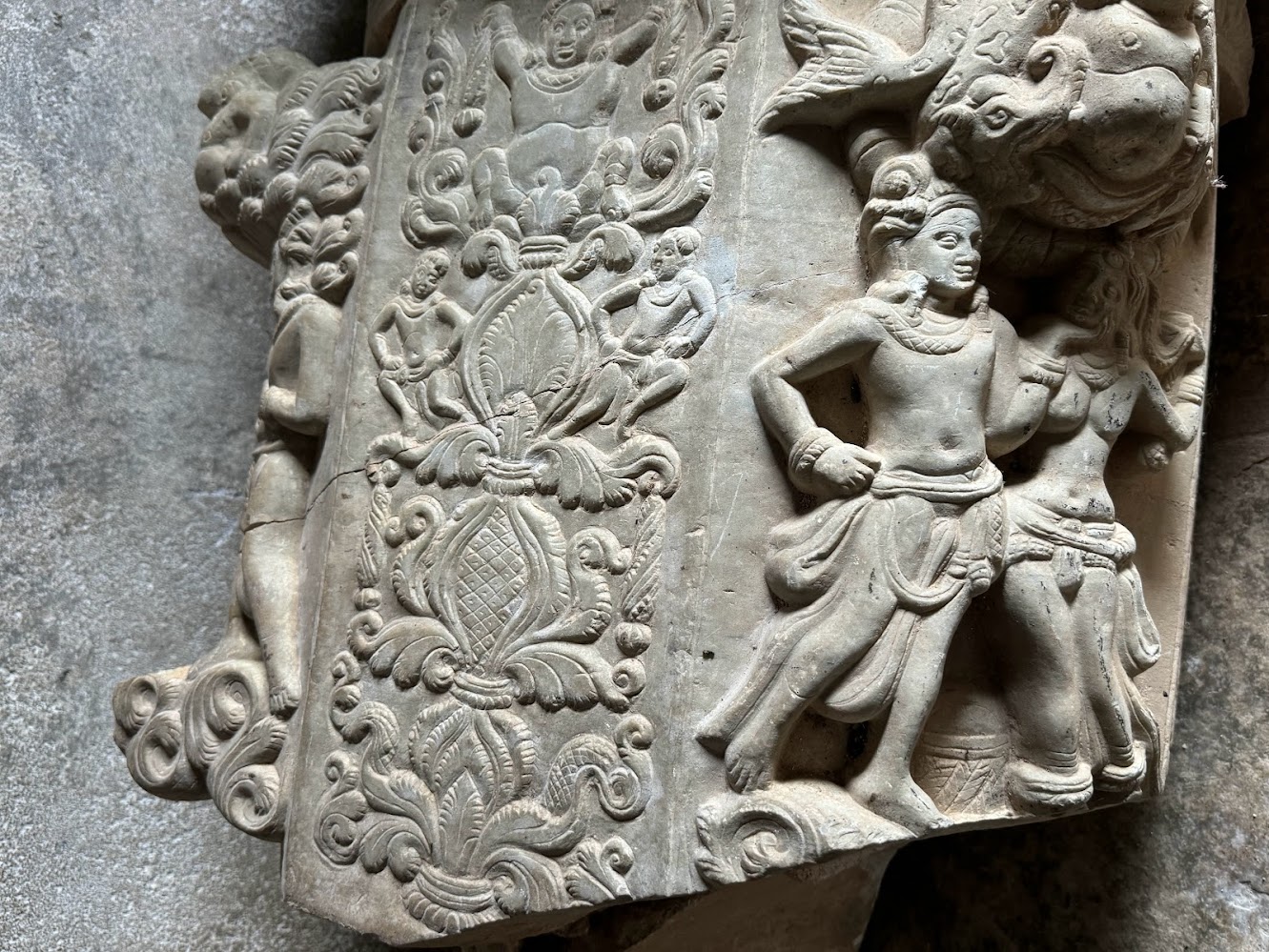 A closer view of the pillar showng a loving couple a mithuna under a unfortunately truncated merman.