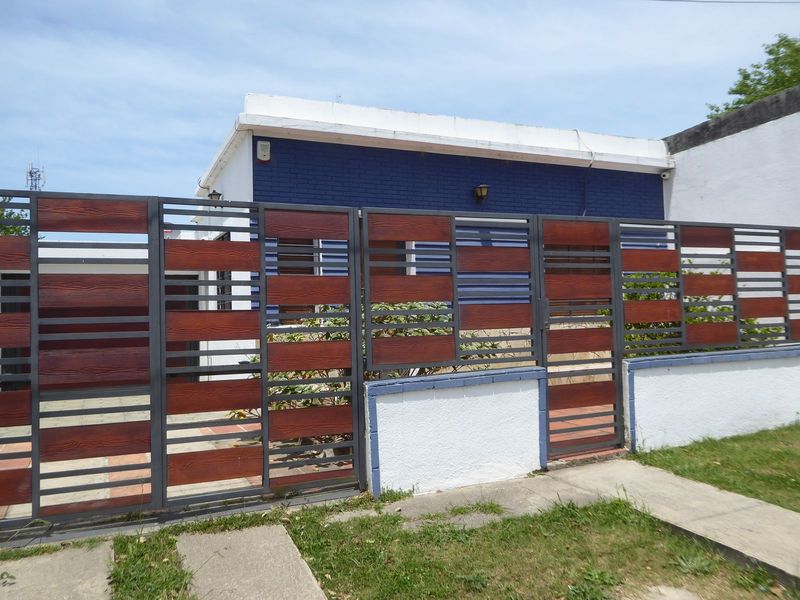 A newesh house with a stylish fence.
