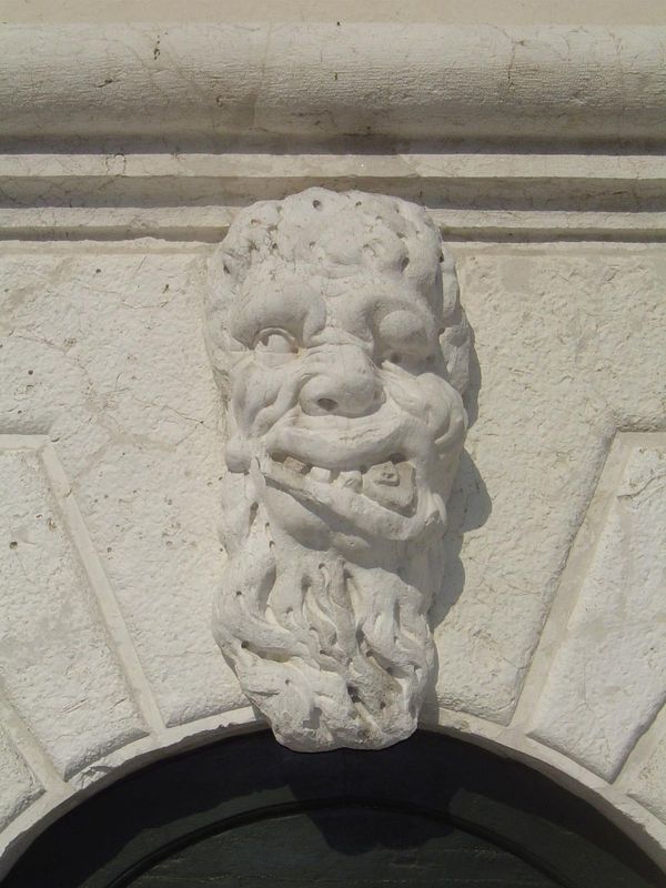 Here it is, and here is what Ruskin says of it: "A head,—huge, inhuman, and monstrous,—learing in bestial degradation, too foul to be either