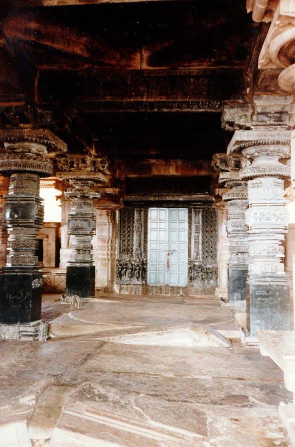 Basalt columns enclose the mandapa in front of the sanctuary with its lingam, here behind closed doors.