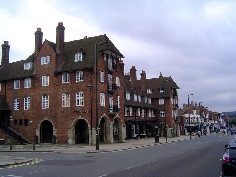 Hampstead Garden Suburb's commercial center developed where several streets converged on Finchley Road. The central block, Arcade House, has