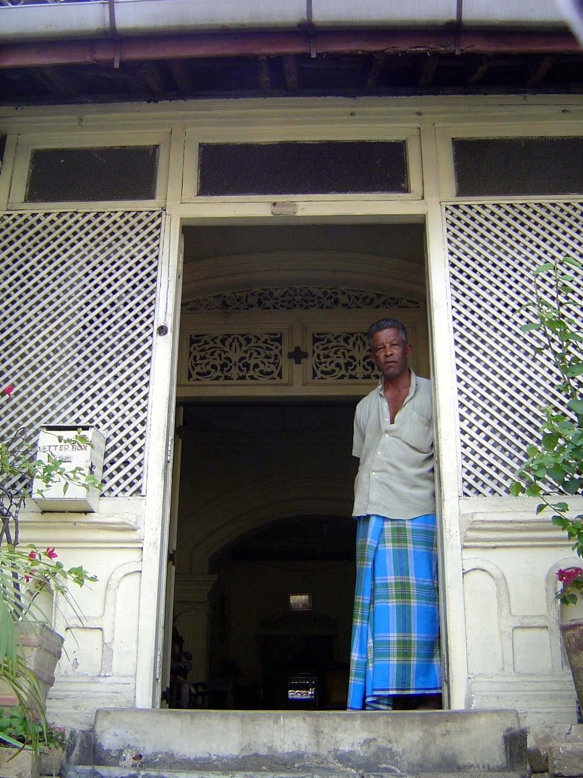 The steps lead to a lattice-screened veranda.