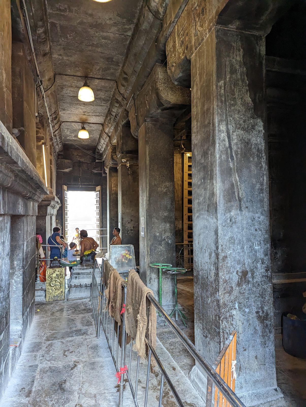 Inside seen here from a side entry, they hope for a peek at a huge Shiva lingam and for the opportunity to make a donation.
