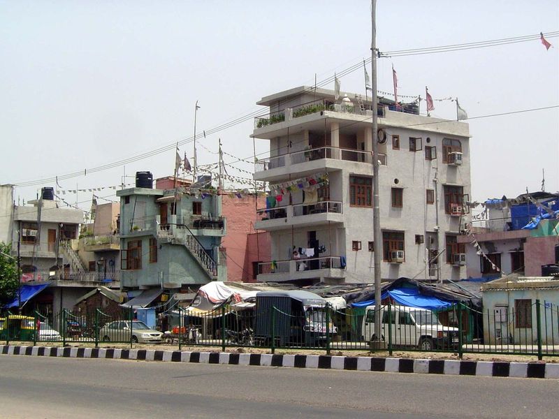 This is Delhi's Outer Ring Road. We'll get across on a pedestrian overpass, but notice first those flags up top.