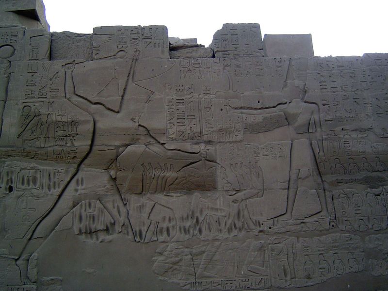 Here, for example, Tuthmose III holds captives by the hair while clubbing them. An inscription reads: "He slays with a club the prisoners of