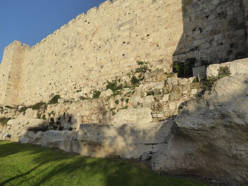 We could even stretch the facts to say that the wall has grown from the underlying rock.
