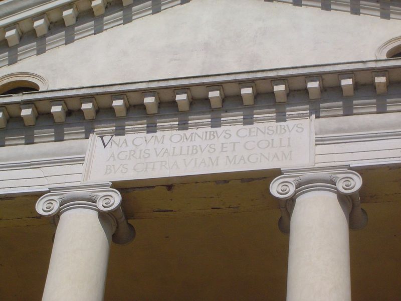 The molding is interrupted by the inscription, clear in the bright sunshine. The complete inscription, spread over the four architraves, rea
