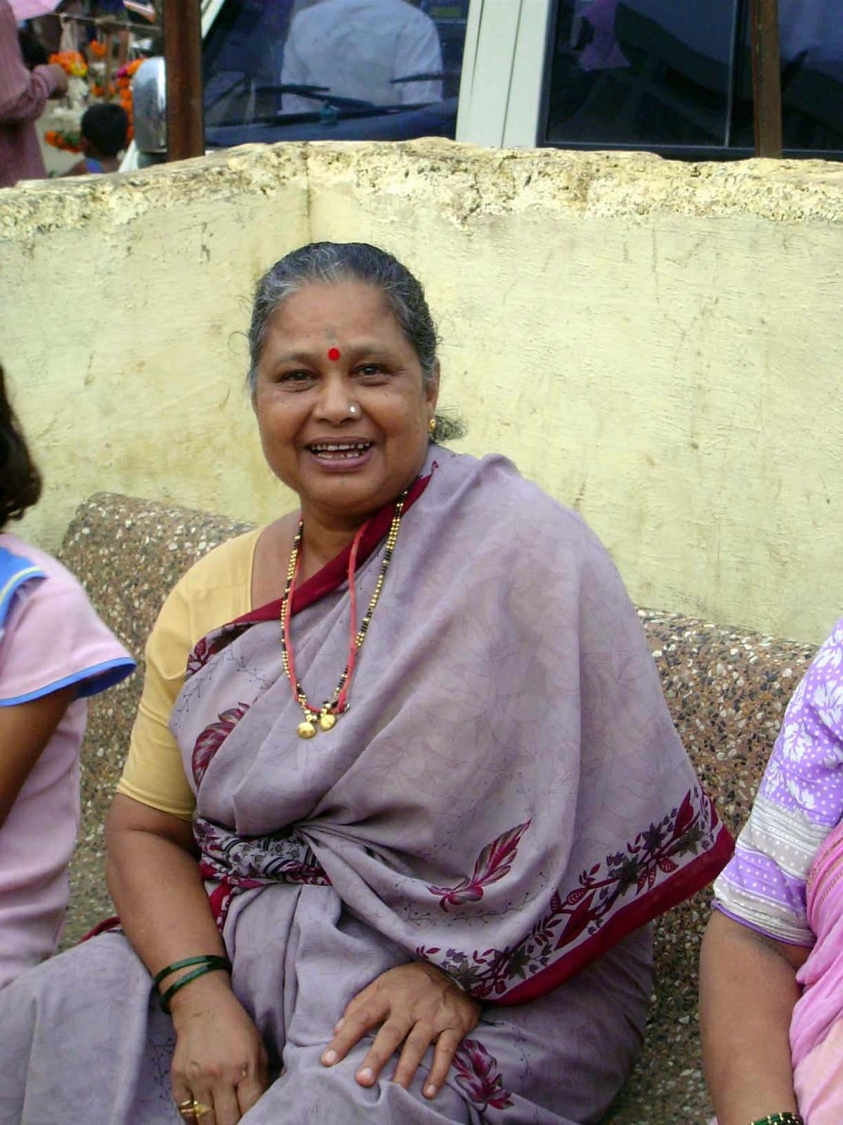 A woman resting in the temple grounds.