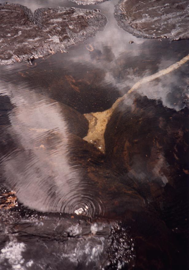 Here and there, asphalt bubbles up in slow-motion turbulence, with ponds of rainwater floating on top.