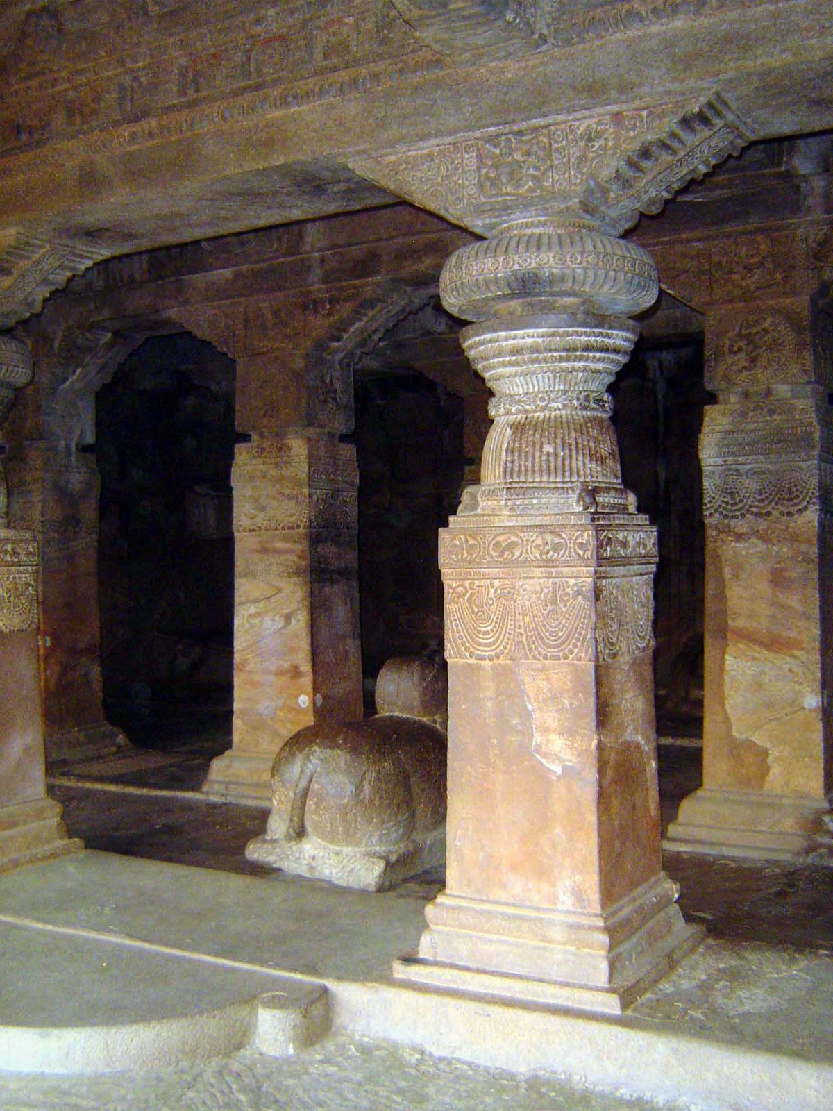 The columns supporting the roof are carved with garlands; Nandi faces the innermost shrine.