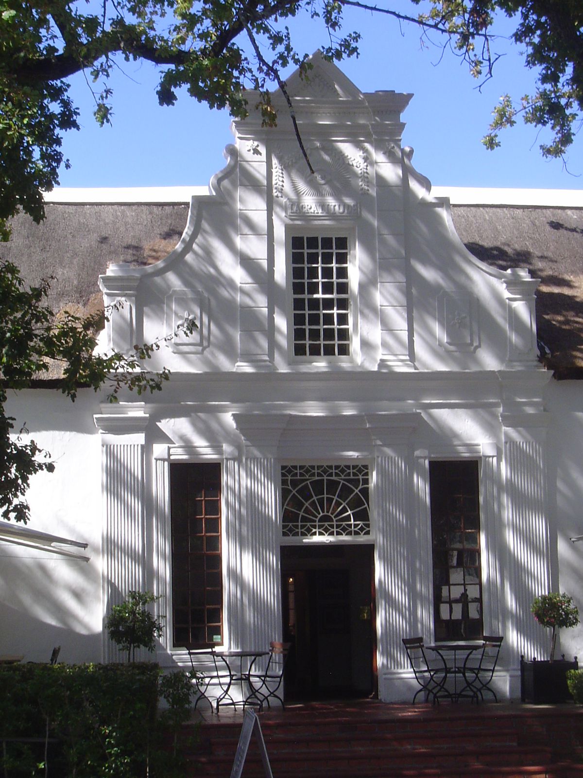 As the gable announces, this is La Gratitude, from 1798. It was the home for 30 years of a minister, which may explain the watchful eye, a r