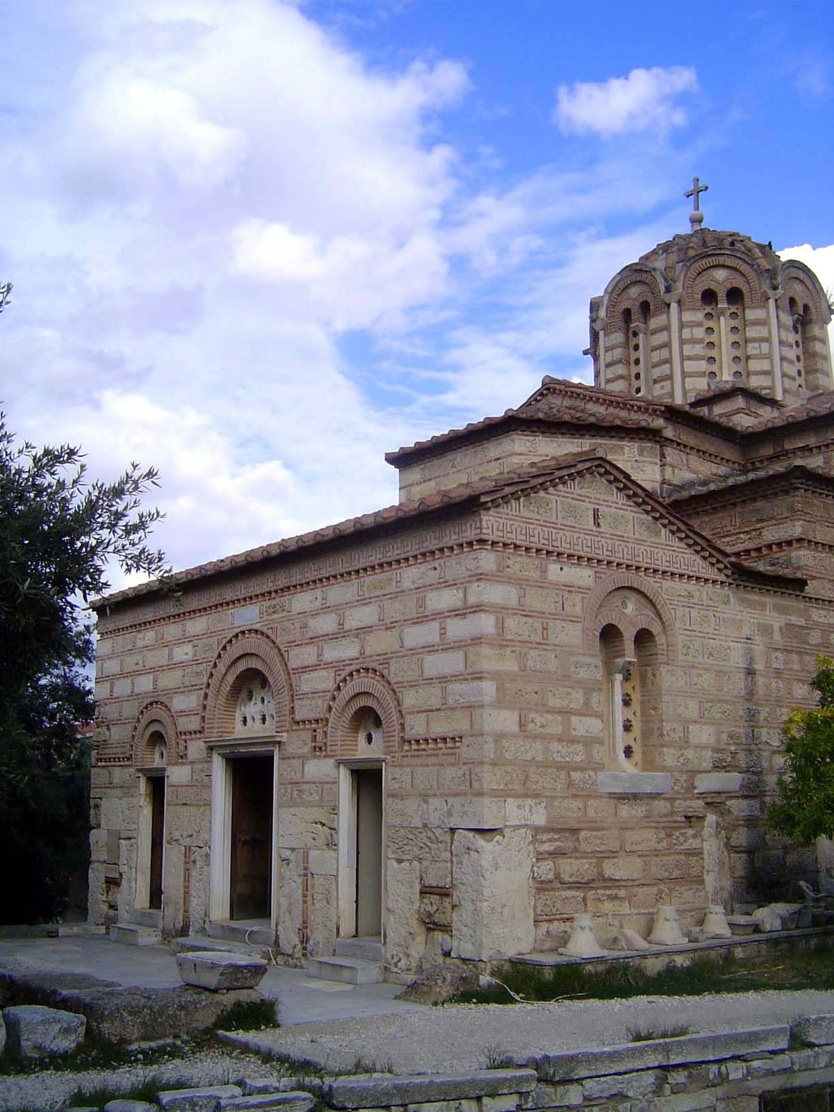 The vestibule, though also constructed of stone rimmed with brick, is a later addition.