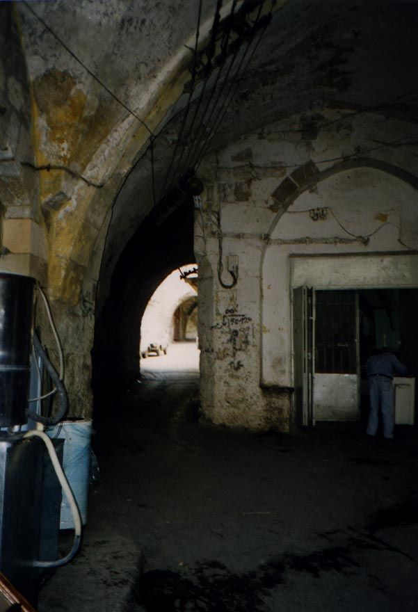 An anarchist triumph: a newer building moves into the tunnel and leaves barely enough space for a car to squeeze through.