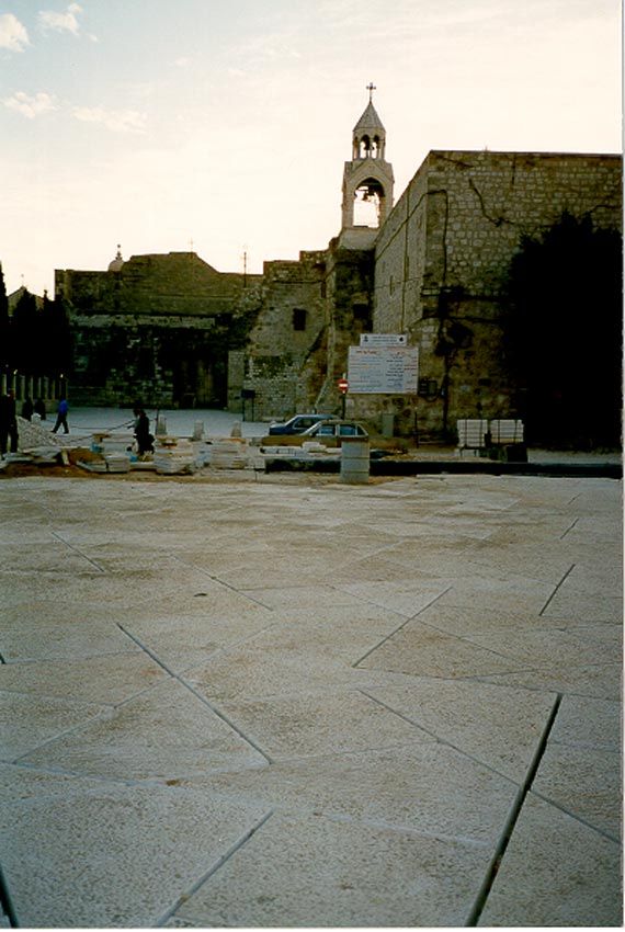 Manger Square, freshly paved with limestone flags laid in a quasi-star pattern. The Church of the Nativity is in the background.