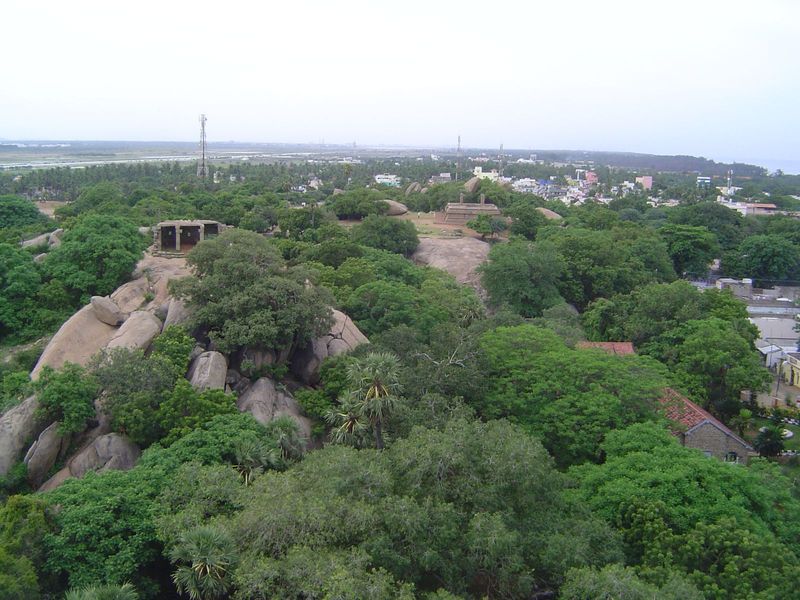 The sea is perhaps a quarter mile to the east. About ten monolithic temples have been scooped from the rocky ridge. The modern town of Mamal