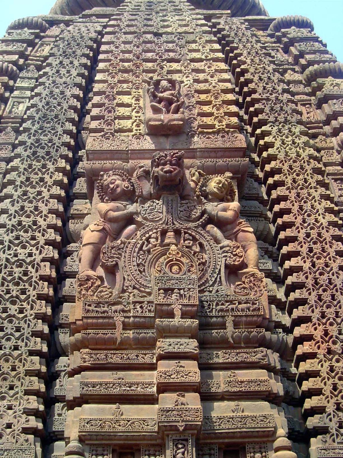 Guards protect the deity peering from the tiny window.