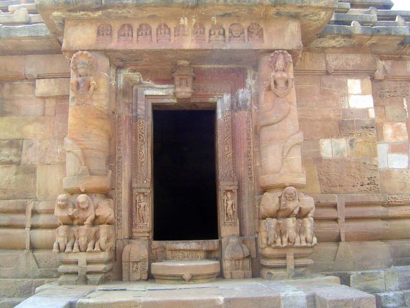 The entrance is guarded by female nagas, with a human head and snake body. They are themselves guarded by seven cobras, whose hoods flare fr