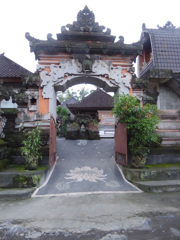 Here's an open gate. It leads to an extended family compound. The name varies depending on the caste of the residents. In any case, writes W