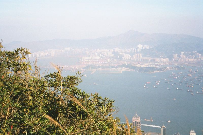 Taken while clinging to the fence around the considerably higher Victoria Peak summit: container terminals are in the center, with Kwai Chun