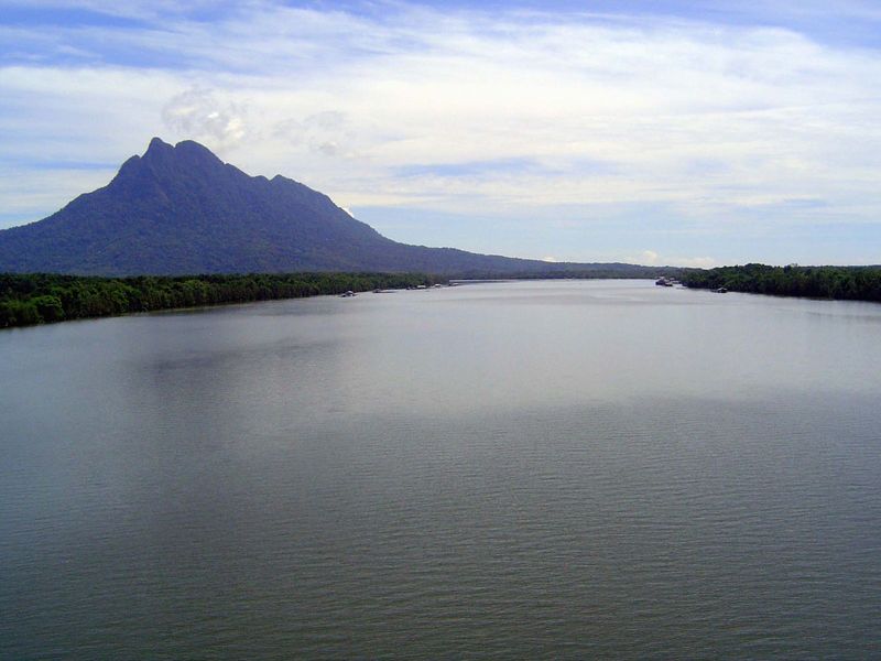 The Santubong River, a distributary of the Sarawak, breasts its way past Santubong Mountain, to whose far slope we're headed.