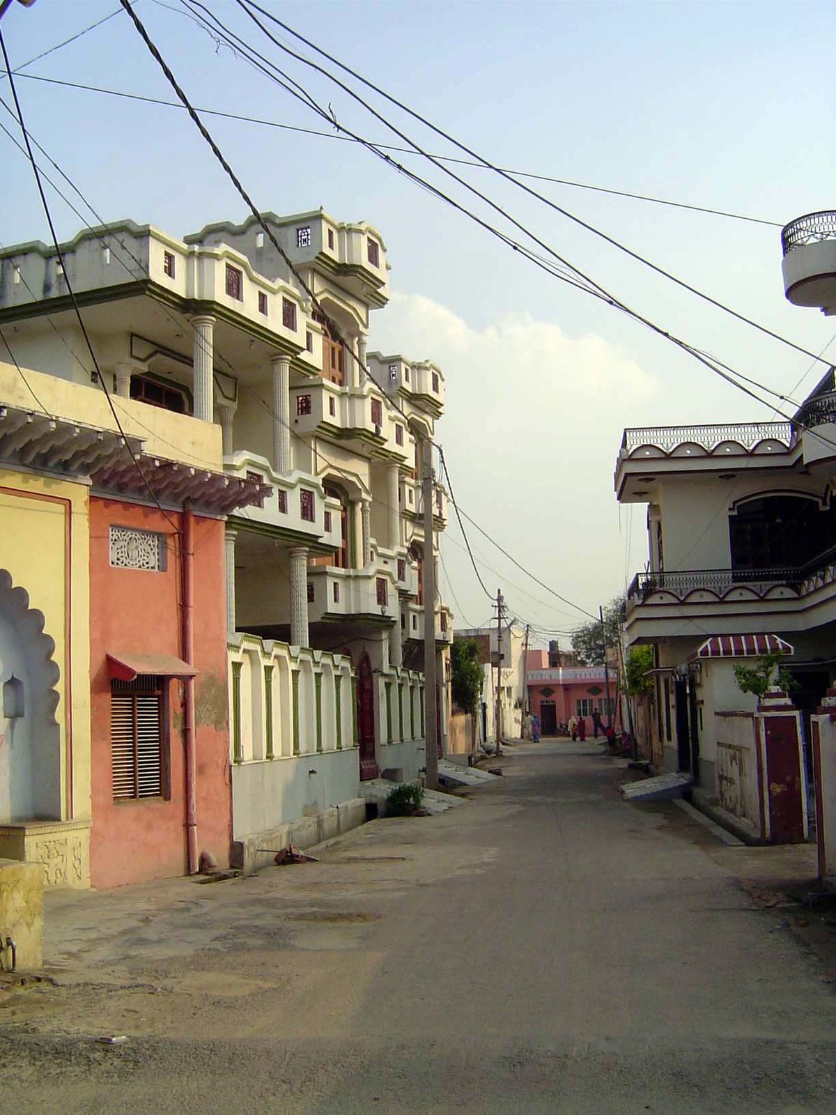 Street scene, with an old though now paved lane and a fine display of family wealth.