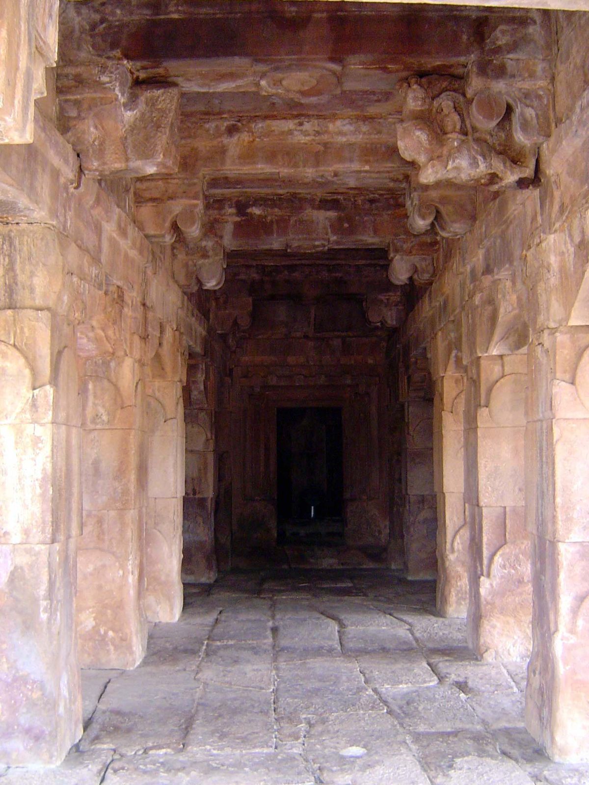 The interior is very simple, but in the dark shrine, the polished granite lingam reflects light.