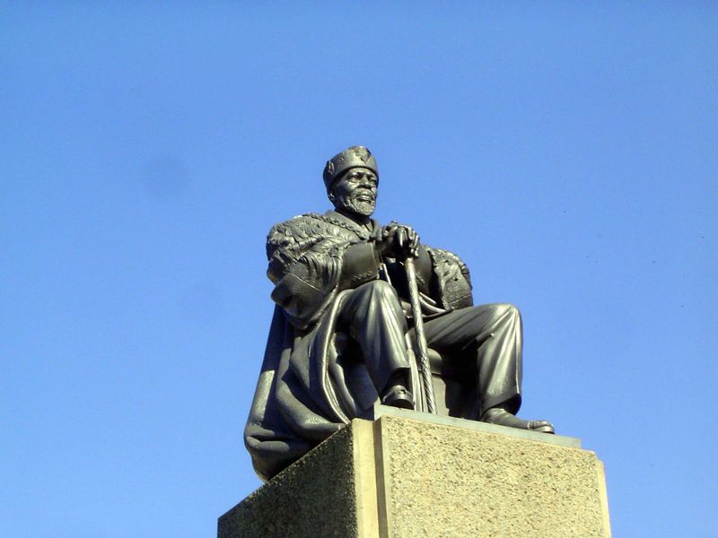 Kenyatta sits and watches.