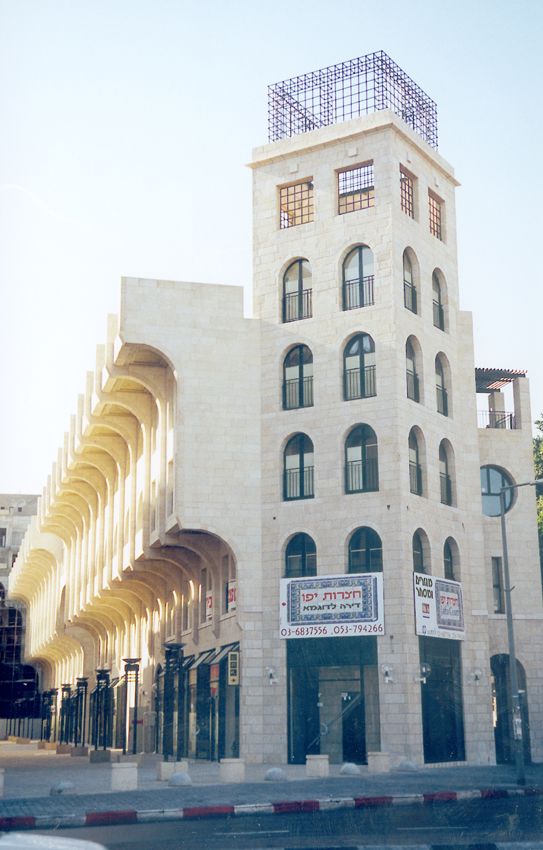 This office building looks around for something else to echo and settles on the sultan's nearby clock tower.