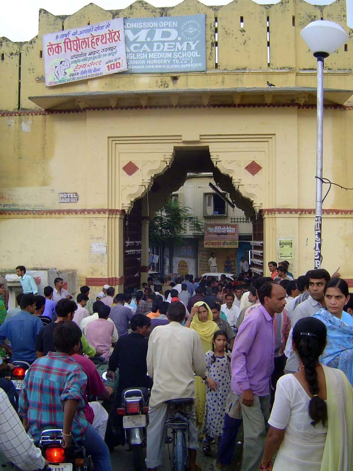 The entry through the Chandpol or moon gate. The view here is from the bridge across the stream issuing from Pichola Lake.