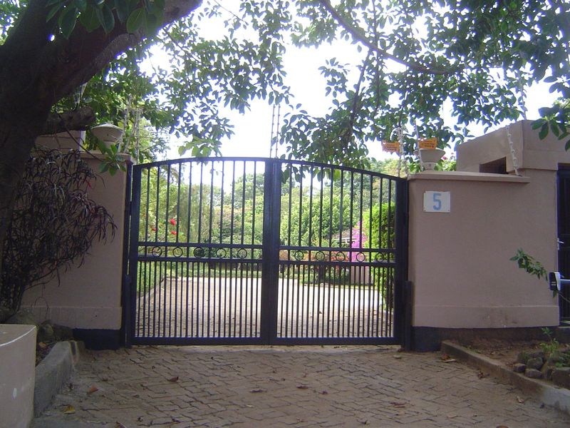 The wall and gates are topped by delicate electric fencing on the South African model.