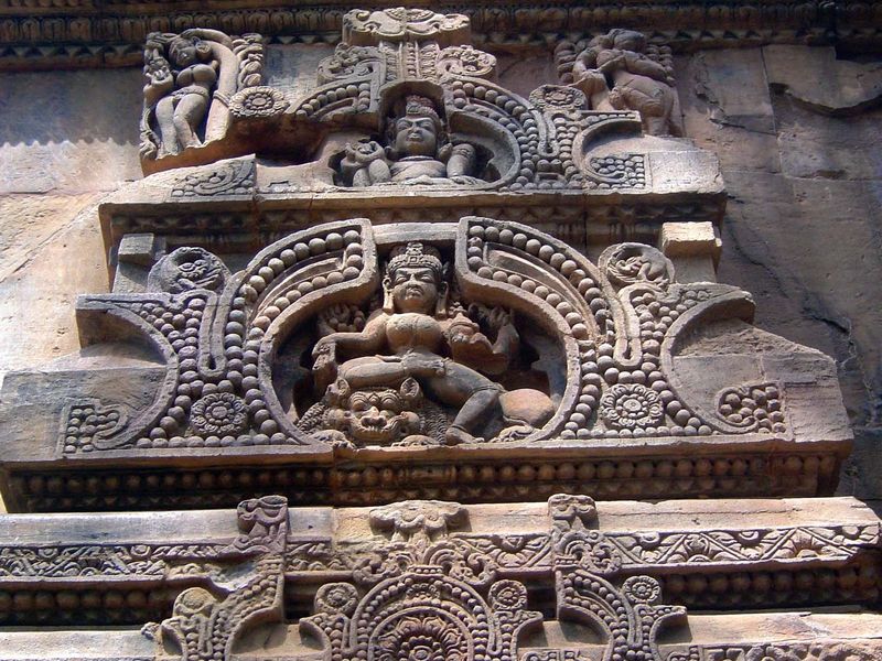 Similarly sheltered by an arch, Shiva dances on another side of the sanctuary over the demon Ravana.