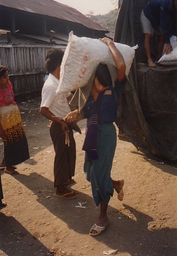 Note the bamboo sticks, proof of how many sacks the porter carried to the ferry.