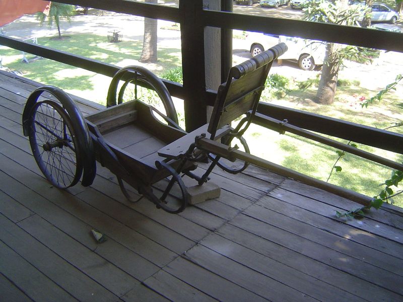 On the upstairs porch, a garetta. It's a ricksha of unusual design but an improvement on the machila, a kind of portable hammock used in the