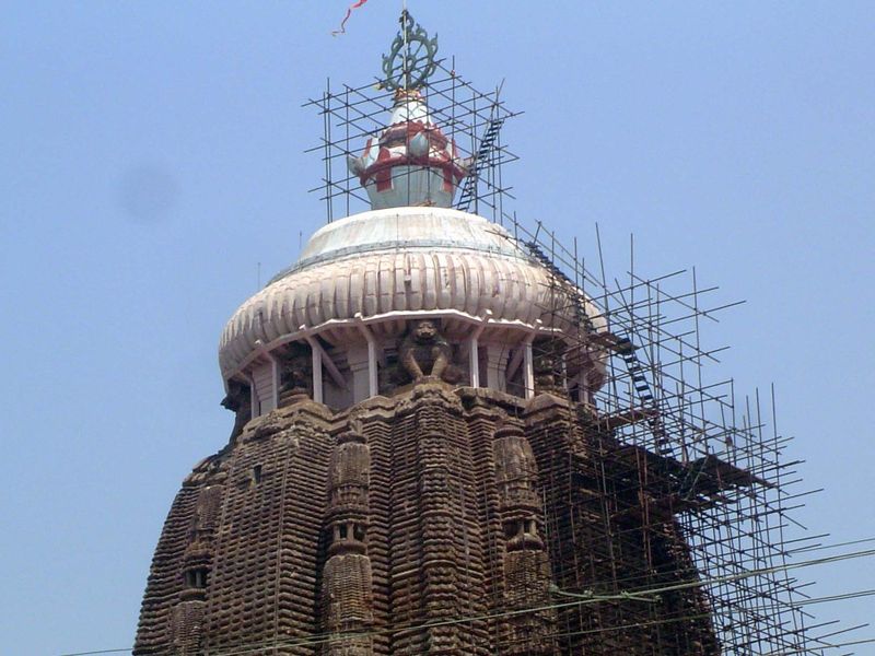 The scaffolding ladder gives a vertiginous sense of the tower's height.