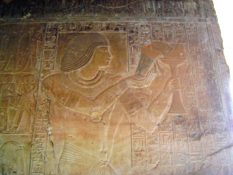 Khaemhet makes an offering; field workers to left.
