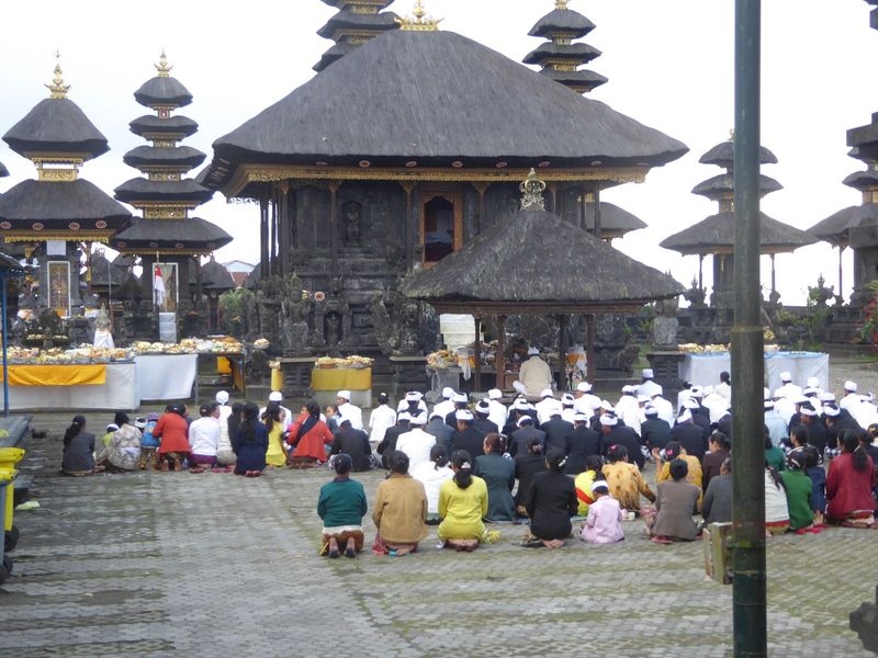 Members of one association kneel before a bale or pavilion. The pyramidal roof is in itself a tipoff that this is a temple: secular building