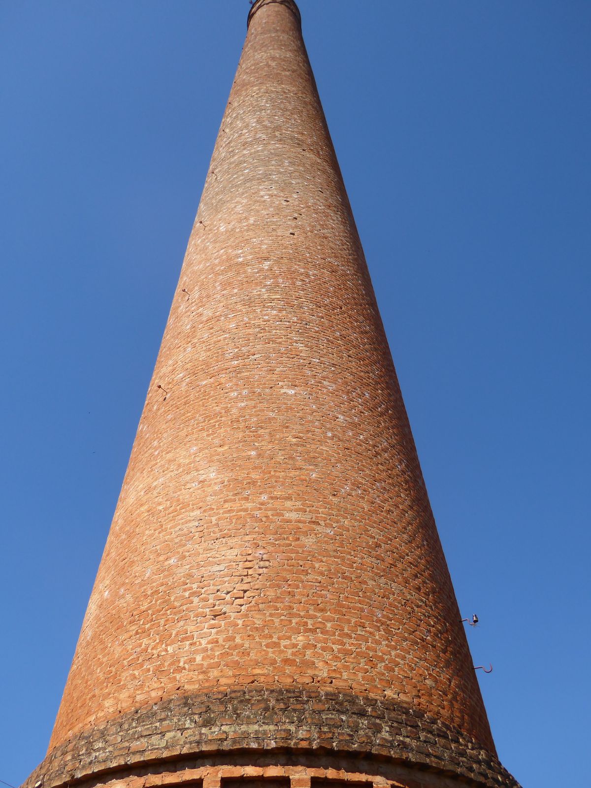 Funny thing: it's a warm day, but there's a cool breeze blowing stiffly from the base of the stack.