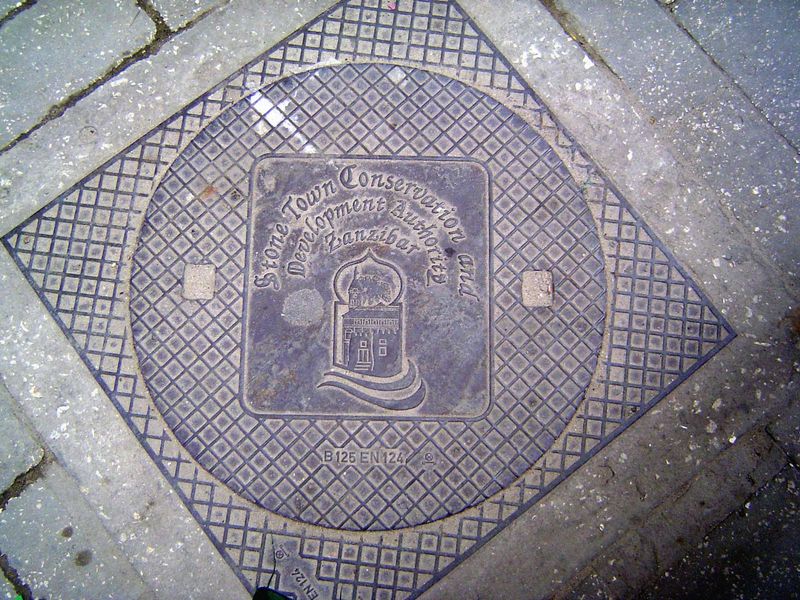 The manhole cover is a reminder of the existence of the Stone Town Conservation and Development Authority, created in 1985. A half-dozen yea
