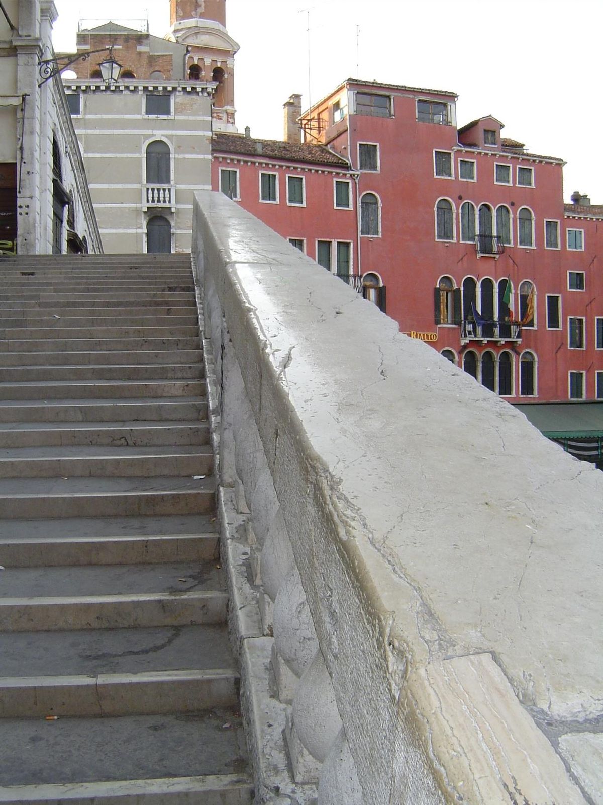 Four hundred years of hands sliding and slapping have brought the stone railings to a high sheen. The hotel behind, unified by color, consis
