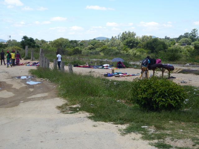 At the edge of town, an impromptu market has sprung up along the track.